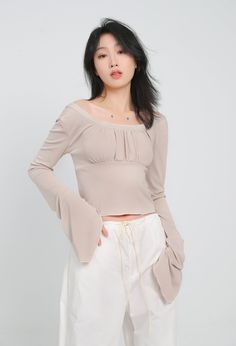 With all the comfort of a casual tee and the style of a dressy top, this crop top is a must-have for your wardrobe. A lightweight and airy fabric makes this crop top a perfect choice for a hot day or a night out on the town. The ruched front detail adds a touch of glamour, while the flare sleeves keep things interesting.
Gender: WomenMaterial: PolyesterClothing Length: ShortSleeve Length: Long SleeveSleeve Type: Angel Sleeve Trendy Fitted Solid Color Blouse, Fitted Solid Color Top For Spring, Chic Flowy Crop Top For Summer, Casual Flowy Off-shoulder Tops, Chic Flowy Crop Top For Day Out, Chic Flowy Top For Night Out, Chic Flowy Summer Crop Top, Fitted Cropped Top For Fall, Casual Summer Blouse For Night Out