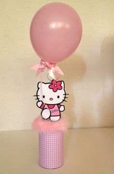 a hello kitty balloon on top of a pink tube