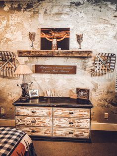 an old dresser with some pictures on it