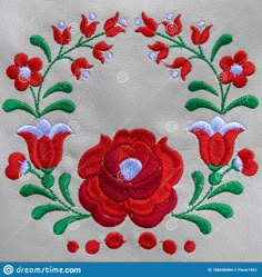 an embroidered red flower with green leaves on white leather background stock images and royalty photos