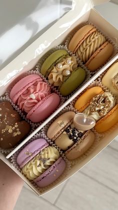 a box filled with lots of different types of macaroons