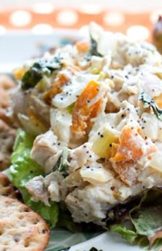 a white plate topped with salad and crackers