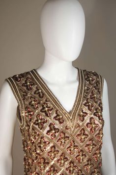 For Sale on 1stDibs - This Galanos blouse is composed of a beaded and sequin appliqued silk, in gold and burgundy hues. The top features a 3-dimensional beading technique. There Elegant V-neck Tops For Reception, Glamorous Embroidered Evening Tops, Festive Embellished V-neck Top, Glamorous Embroidered Tops For Evening, Embellished Party Wear Tops, Gold Embellished Sleeveless Top, Festive Party Wear Tops Hand Embellished, Embellished Fitted Tops For Party, Embellished Fitted Party Tops