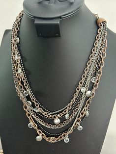 Add some flair to your jewelry collection with this stunning Lia Sophia 'Hotspot' necklace. The piece features nine chains layered together in a unique and eye-catching design. The necklace is made of high-quality copper and silver-tone metal which gives it a stylish and modern look.  This necklace is perfect for any occasion, whether you're dressing up for a night out or adding a touch of elegance to your everyday wear. The Lia Sophia brand is known for its high-quality jewelry, and this necklace is no exception. With its intricate design, it's sure to be a conversation piece and a staple in your jewelry collection. Chains Layered, Lia Sophia, Wedding Jewellery Necklace, Wedding Necklaces, Jacksonville Fl, Intricate Design, Wedding Necklace, High Quality Jewelry, Conversation Piece