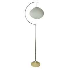 a floor lamp with a white ball on the top and a metal pole below it