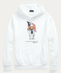 AUTHENTICITY GUARANTEED Style: Polo Ralph Lauren Limited Edition Bear Sweater Color: White Description: Get into the Olympic spirit with this cotton-blend hoodie. At the front, it features our iconic Polo Bear sporting an entire outfit from the Team USA collection while proudly waving the American flag. Size medium has a 27½" body length (front and back), an 18½" shoulder, a 44½" chest, and a 35" sleeve length. Sleeve length is taken from the center back of the neck and changes 1" between sizes. Polo Bear By Ralph Lauren, Bear Sweater, Olympic Team, Polo Bear, The American Flag, Team Usa, Usa Flag, Fleece Hoodie, Colorful Sweaters