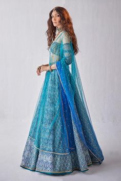 Blue lehenga featuring floral Mughal prints and sequin work. Paired with a padded off-shoulder blouse and an ombre dupatta., Fit: Relaxed Blue Choli With Sheer Dupatta For Navratri, Blue Semi-stitched Anarkali Set With Meenakari, Blue Anarkali Choli With Sheer Dupatta, Semi-stitched Blue Anarkali Set With Meenakari, Festive Blue Lehenga With Cutdana, Blue Cutdana Lehenga For Festive Occasions, Blue Meenakari Anarkali Set For Festive Occasions, Blue Meenakari Anarkali Set For Eid, Fitted Blue Traditional Wear With Meenakari