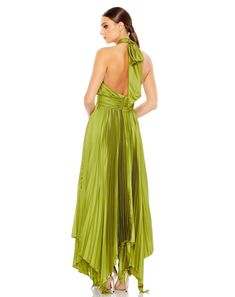 a woman in a green dress is looking back