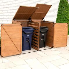 an open wooden storage box with two trash cans and one blue bin in the middle