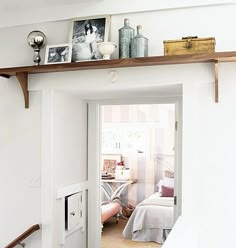 an open door leading to a bedroom with pictures on the wall