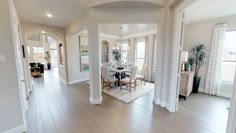 a dining room and living room with hardwood floors