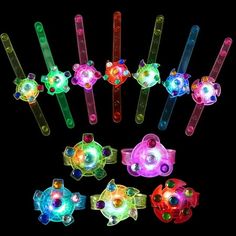 many different colored lights are in the shape of fish and turtle shaped objects on a black background