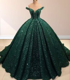 Radiate elegance and sparkle in this Dark Green Off-the-Shoulder Sequined Ball Gown Quinceanera Dress. This dress is crafted with shimmering sequin fabric that catches the light from every angle, making you the center of attention. It is available in rich dark green and vibrant red. The off-the-shoulder neckline highlights your decolletage with a graceful touch, while the sleeveless design adds timeless sophistication. A lace-up back adds a customizable fit, combining comfort with beauty. The cl Dark Green Wedding Dress, Dark Green Quinceanera Dresses, Emerald Green Quinceanera Theme, Green Quince Dress, Green Wedding Dress, Xv Dresses, Green Ball Gown, Dark Green Wedding, Green Quinceanera Dresses