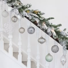 christmas decorations are hanging on the banister