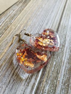 Beautiful natural rose petals in heart resin earrings. Hues of amber red paired with fiery copper flakes make these natural earrings boldly colorful. Bronze metal earrings with handmade resin heart pendants with real dried rose petals ♥ Be sure to check out the ORANGE EARRINGS section at EarringsbyLCreations for all beautiful orange colored earrings available! https://www.etsy.com/shop/EarringsByLCreations?section_id=28420987 Made with quality materials and always nickel and lead free metals. Na Valentine's Day Heart-shaped Flower Earrings For Pierced Ears, Pink Heart-shaped Flower Earrings For Gift, Pink Heart-shaped Flower Earrings As Gift, Heart-shaped Resin Jewelry For Valentine's Day, Heart Shaped Resin Jewelry For Valentine's Day, Valentine's Day Heart-shaped Resin Jewelry, Resin Heart Earrings For Gifts, Gold Heart-shaped Flower Earrings, Heart-shaped Gold Flower Earrings For Valentine's Day