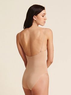 Capezio's seamless camisole undergarment includes nude and clear adjustable shoulder straps. The back neckline has six hook positions for versatile adjustment. The seamless Tactel Nylon blend contours and shapes the dancer's body. Moderate cut leg line. Machine wash in cold water, hang dry. Capezio Adult Seamless Camisole Undergarment Nude XL 3680 Cami Bodysuit With Built-in Bra, Solid Color Cami Bodysuit With Built-in Bra, Second-skin Camisole Bodysuit With Built-in Bra, Seamless Fitted Bodysuit With Spaghetti Straps, Solid Seamless Bodysuit With Spaghetti Straps, Seamless Solid Color Bodysuit With Spaghetti Straps, Nylon Bodysuit With Built-in Bra And Scoop Neck, Nylon Camisole With Built-in Bra, Stretch Bodysuit With Spaghetti Straps