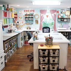 a kitchen with lots of crafting supplies on the counter and shelves filled with books