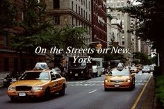 taxi cabs driving down the street in new york city with words on the streets or new york