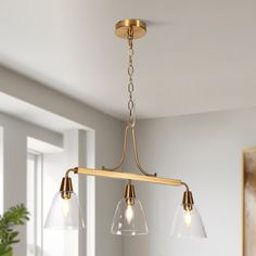 a kitchen light with three lights hanging from the ceiling