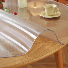 a close up of a table with a cup and saucer on the table next to it