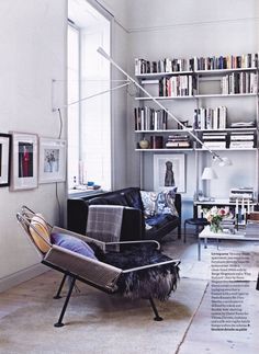 a living room filled with furniture and bookshelves