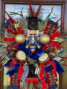 a christmas wreath with a nutcracker and bells