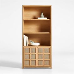 a wooden bookcase with two books on top of it and some other items in the bottom shelf