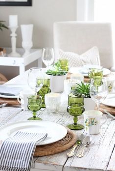 the table is set with dishes and place settings