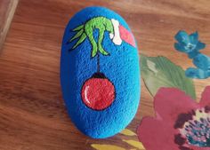 a painted rock sitting on top of a wooden table