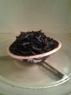 a bowl filled with chocolate sprinkles sitting on top of a glass plate