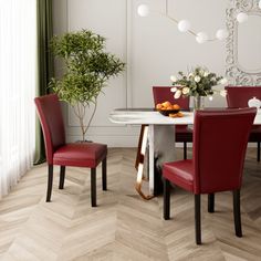 a dining room table with red chairs next to a plant and potted plant on top of it