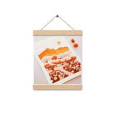 a wooden frame hanging on a wall with an orange and white photo in the background