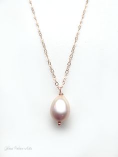 "Champagne Pink Freshwater Pearl Necklace ~ Available in 100% 14k gold fill, rose gold fill or sterling silver Capture the beauty of genuine pearls with this simple, elegant pearl drop necklace. ~ Genuine freshwater pearls have a gorgeous luster and the most beautiful champagne blush pink ~ Chain is a dainty and sparkly 14k gold fill, sterling silver or rose gold fill ~ Necklace closes with a spring clasp ~ Shown on model at 18\" length ~ Necklace is handcrafted, made to order, and packaged for Delicate Oval Rose Gold Jewelry, Formal Rose Gold Briolette Necklace, 14k Gold Rose Gold Pearl Drop Jewelry, Rose Gold 14k Jewelry With Pearl Drop, 14k Rose Gold Jewelry With Pearl Drop, Delicate Rose Gold Teardrop Jewelry, Delicate Rose Gold Pear-shaped Jewelry, Rose Gold Teardrop Necklace With Pearl Pendant, Delicate Rose Gold Jewelry With Pearl Pendant