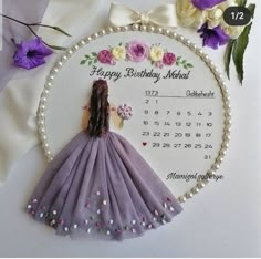 a birthday card with a purple dress and flowers