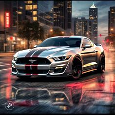 a silver mustang car driving down a city street at night with lights on and buildings in the background