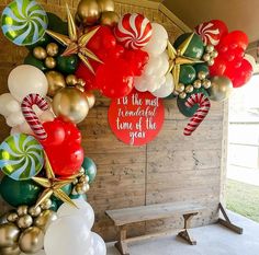 the balloon arch is decorated with red, white and green christmas balloons that say it's the most wonderful time of the year