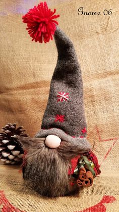 a gnome's hat with a red pom - pom attached to it