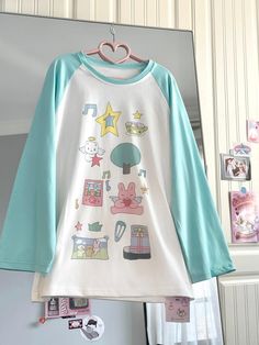 Step into a world of cuteness with our adorable comic-style print top! This charming piece features delightful prints of stars, bunnies, and other whimsical motifs, making it a perfect choice for those who love kawaii fashion. The playful designs add a touch of fun and personality to your outfit, ensuring you stand out in any crowd. Add this adorable piece to your wardrobe and embrace your love for all things cute and playful!  Please note that the price includes only the top.  SizeSMLength6870B Fun Cartoon Print Tops For Spring, Fun Cartoon Print Crew Neck Top, Spring Fun Tops With Cartoon Print, Fun Cartoon Print Spring Tops, Kawaii Cotton Crew Neck Top, Cute Multicolor Tops With Graphic Print, Kawaii Cotton Tops With Character Print, Cute Cotton T-shirt With Anime Print, Kawaii Cotton Tops With Letter Print