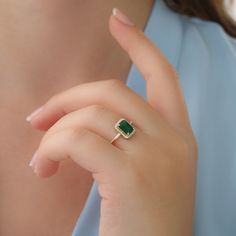 "14k Gold Emerald and Diamond Ring / Solid Gold Diamond Ring / Emerald Engagement Ring / Halo Rectangular Setting / Dainty Emerald Ring ✔ Handmade ✔ Setting Size: 9.5 x 7.5 mm ✔ Diamond Ct Weight: 0.09ctw ✔ Emerald Ct Weight: 1.15 All our emeralds are treated natural emeralds (Emeralds are typically treated with oil or other \"fillers\" to draw the filling substance into any surface-reaching fissures to improve the clarity of the emerald) ✔ Band Thickness: 1.2mm ✔ Solid Gold ✔ Natural Diamonds a Ring Designs With Green Stone, Emareld Ring Design, Emerald Finger Ring Gold, Emerald Rings Design, Green Emerald Ring Gold, Gold Rings With Green Stone, Gold Ring Emerald Stone, Emerald Gold Rings, Anniversary Jewelry With Rectangular May Birthstone