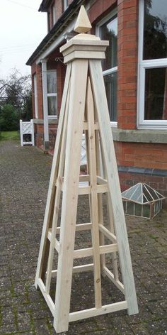 a wooden easel leaning against a brick building