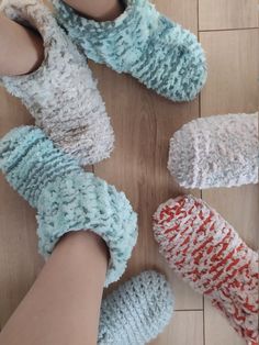 three pairs of slippers on the floor with one person's feet in them