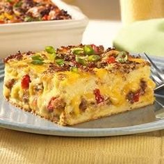 a slice of breakfast casserole on a plate with a fork next to it