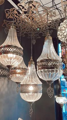 several chandeliers hanging from the ceiling in a room