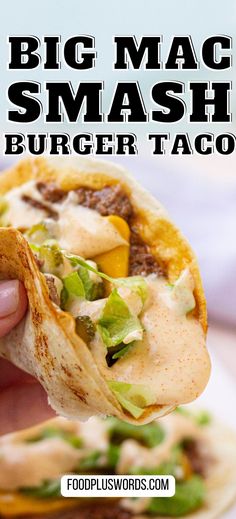 a hand holding up a taco filled with meat and veggies on it