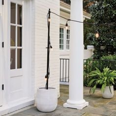 an outdoor area with two large white planters