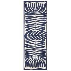 a blue and white runner rug with an abstract design on the bottom, in front of a