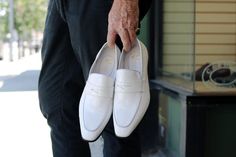 Modern White Slip-ons For Work, White Closed Toe Slip-ons For Office, White Pointed Toe Slip-ons For Work, Modern White Slip-on Loafers, Classic Semi-formal Slip-ons For Spring, White Pointed Toe Leather Shoes For Semi-formal Occasions, Classic White Almond Toe Slip-ons, White Almond Toe Slip-ons For Business, Fitted White Dress Shoes For Office