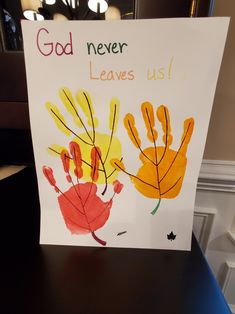 a handprinted card that says god never leaves us