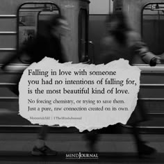 two people walking past a train with a sign that says falling in love with someone you had no intentionss of falling for is the most beautiful kind of love