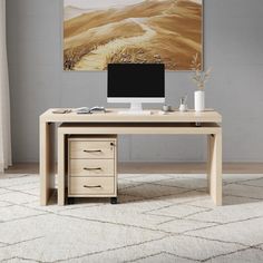 an office desk with two drawers and a computer monitor on it, in front of a painting